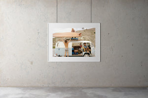A Photo of two surfers putting their vintage longboards on the roof of an old Kombi van.  A young girl inside the Kombi smiling at the camera.  artwork, Prints, wall art, photographic prints,      prints, ocean, framed artwork, photography, film photography, vintage photo style,  Interior design, beach, buy art, photography art, buy art, Prints for sale, art prints, colour photography, sun, beach, sun baking, retro, interior design artwork, surfing, Kombi van, Malibu