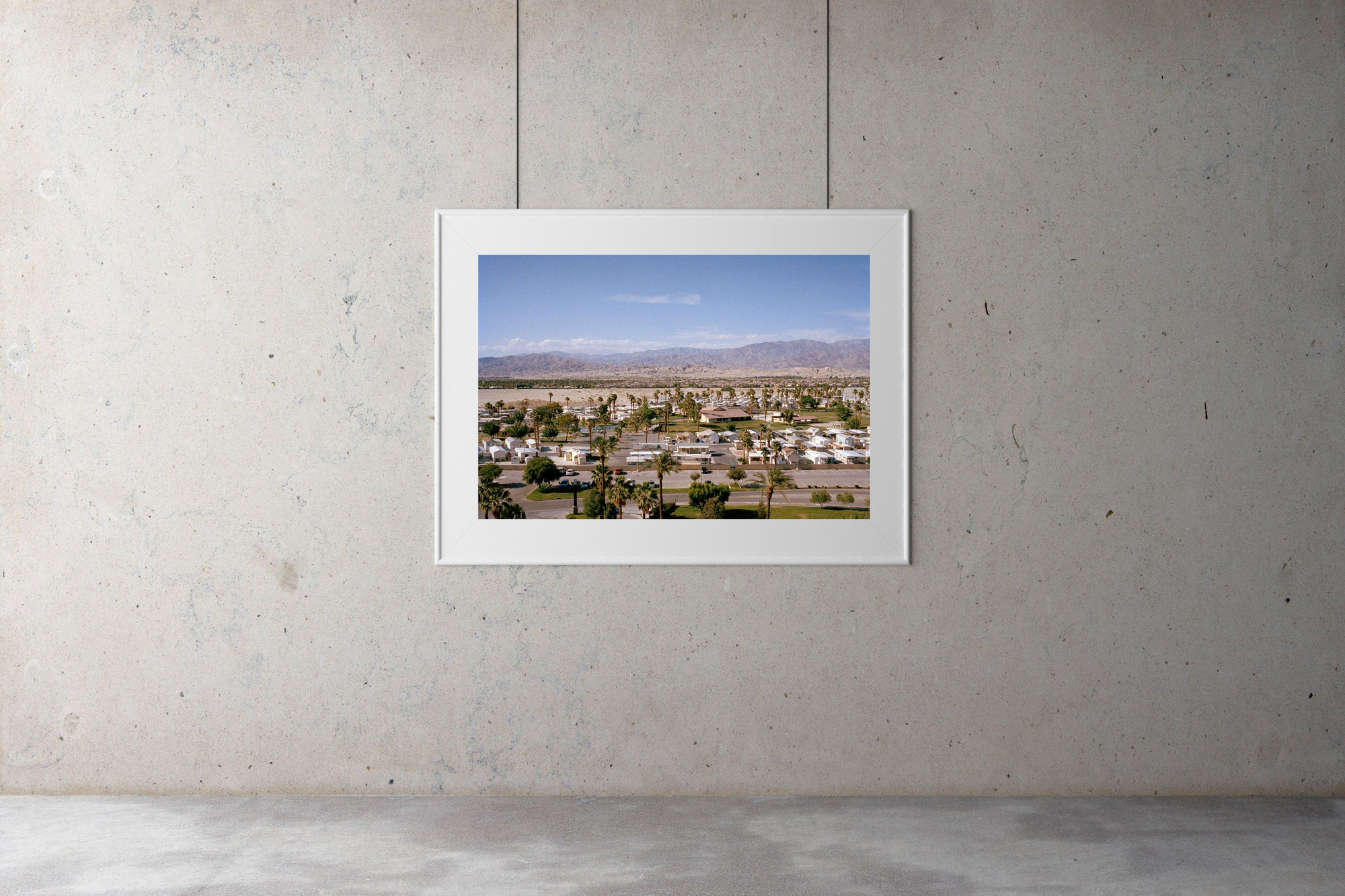 A photograph taken from a high vantage point of a large caravan park with mountains & desert in the background, Palm tree, Coachello, Indio, USA, Artwork, Prints, wall art, California, Photographic prints, Ocean Palm Springs, Framed artwork, Photography,  Film photography, Vintage photo style,  Interior design, beach, buy Art, photography art, buy art, ace hotel, Prints for sale, art prints, colour photography, surfing, surfboard, Malibu, Malibu,  surfing, sun, beach, sun baking, mid century