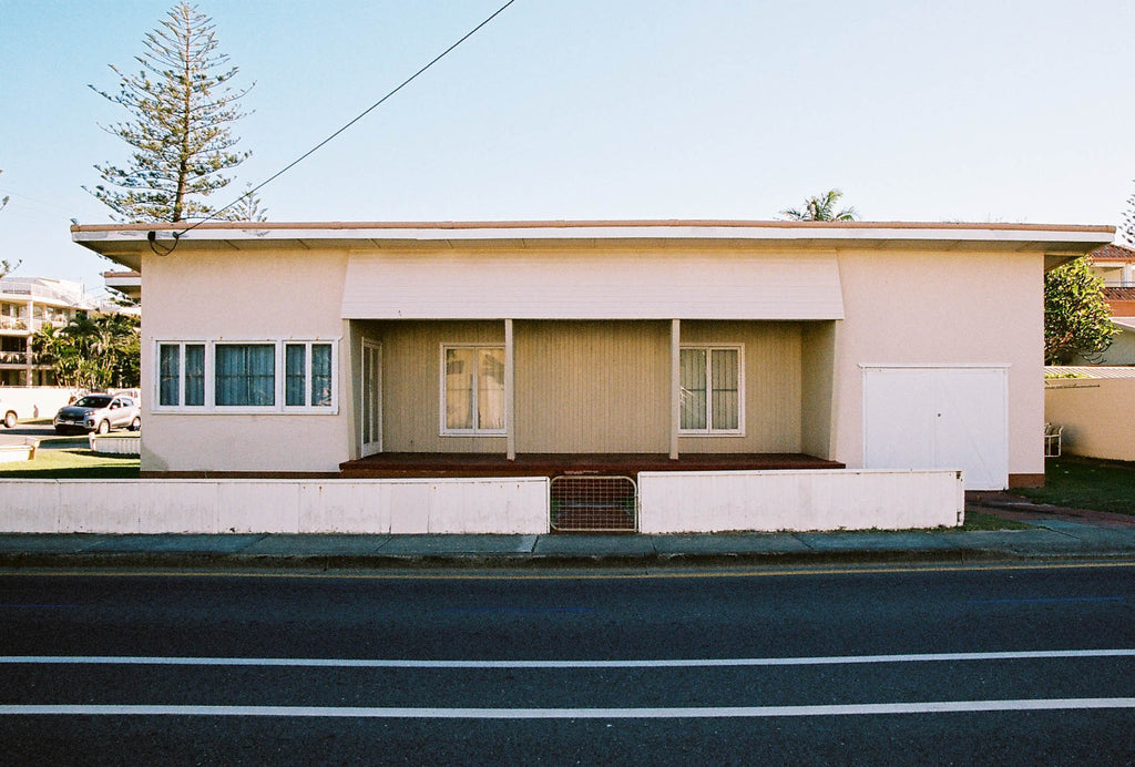 “A 1950’s wood panelled house, painted cream colour with an Art Deco vintage style on a street”. Artwork, Prints, wallart, GoldCoast Queensland Australia, Photographic prints, Ocean Beach, Framed artwork, Beach Posters   Film photography, Vintage photo style,  Interior design, Film photography Pictures sun & surf, photography art