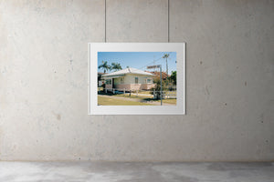 A 1950's beach house painted pink & white with a tin roof, retro style windows located on the Gold Coast of Queensland Australia. The sky is blue & there are tall palm trees. Artwork Prints, wall art, GoldCoast Queensland, Australia, Photographic prints, Ocean, Beach, Framed artwork, Beach Posters, Australian Photography, Photography for sale, Film photography ,Vintage photo style Interior design, Film photography, Pictures, sun, surf , wall art, prints for sale, architecture,