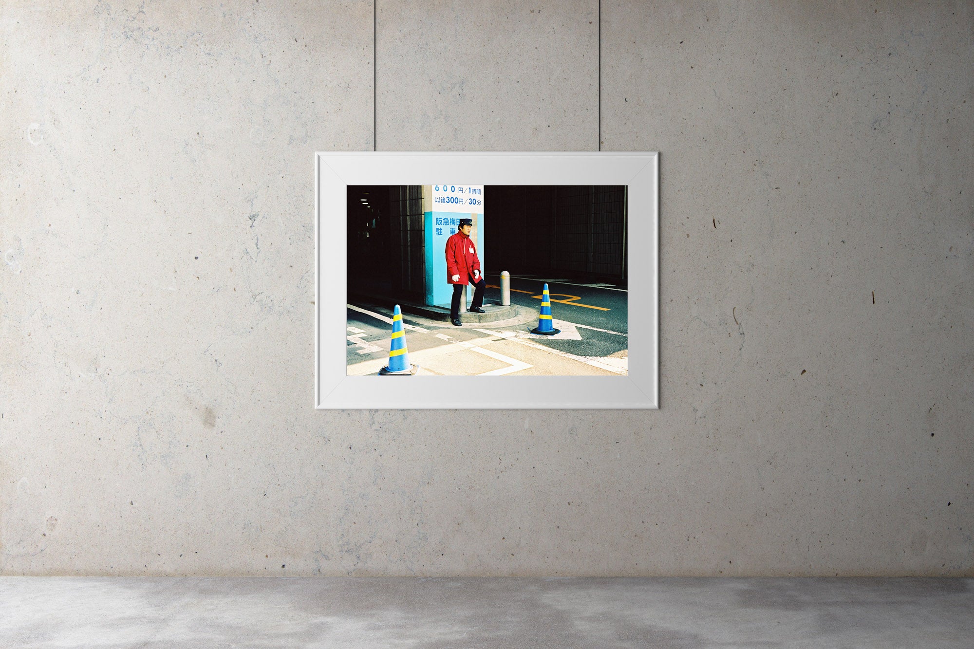 A parking attendant sitting outside a Japanese carpark entrance. He wears a red uniform with a black cap. Artwork Prints, wall ar,t Japan, Osaka, Photographic prints,, Framed artwork,  Posters  Photography Photography for sale, Film photography, Vintage photo style,  Interior design, Film photography, Pictures framed, artwork, travel photography, 35mm fil