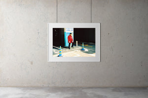 A parking attendant sitting outside a Japanese carpark entrance. He wears a red uniform with a black cap. Artwork Prints, wall ar,t Japan, Osaka, Photographic prints,, Framed artwork,  Posters  Photography Photography for sale, Film photography, Vintage photo style,  Interior design, Film photography, Pictures framed, artwork, travel photography, 35mm fil